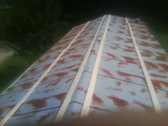 Rusted metal roof panels with new wood purlins before replacement — Storm Damage Roof Repair in Stormville by Roofing Brothers