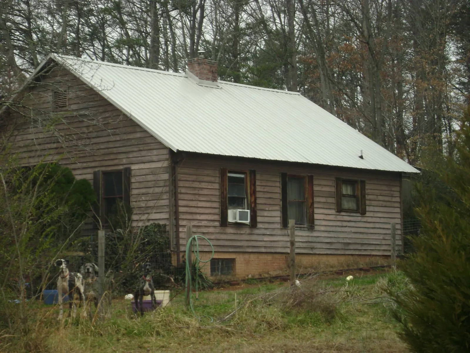 White metal roof on an old wood sided farmhouse, from a Metal Roof Installation job in Stormville